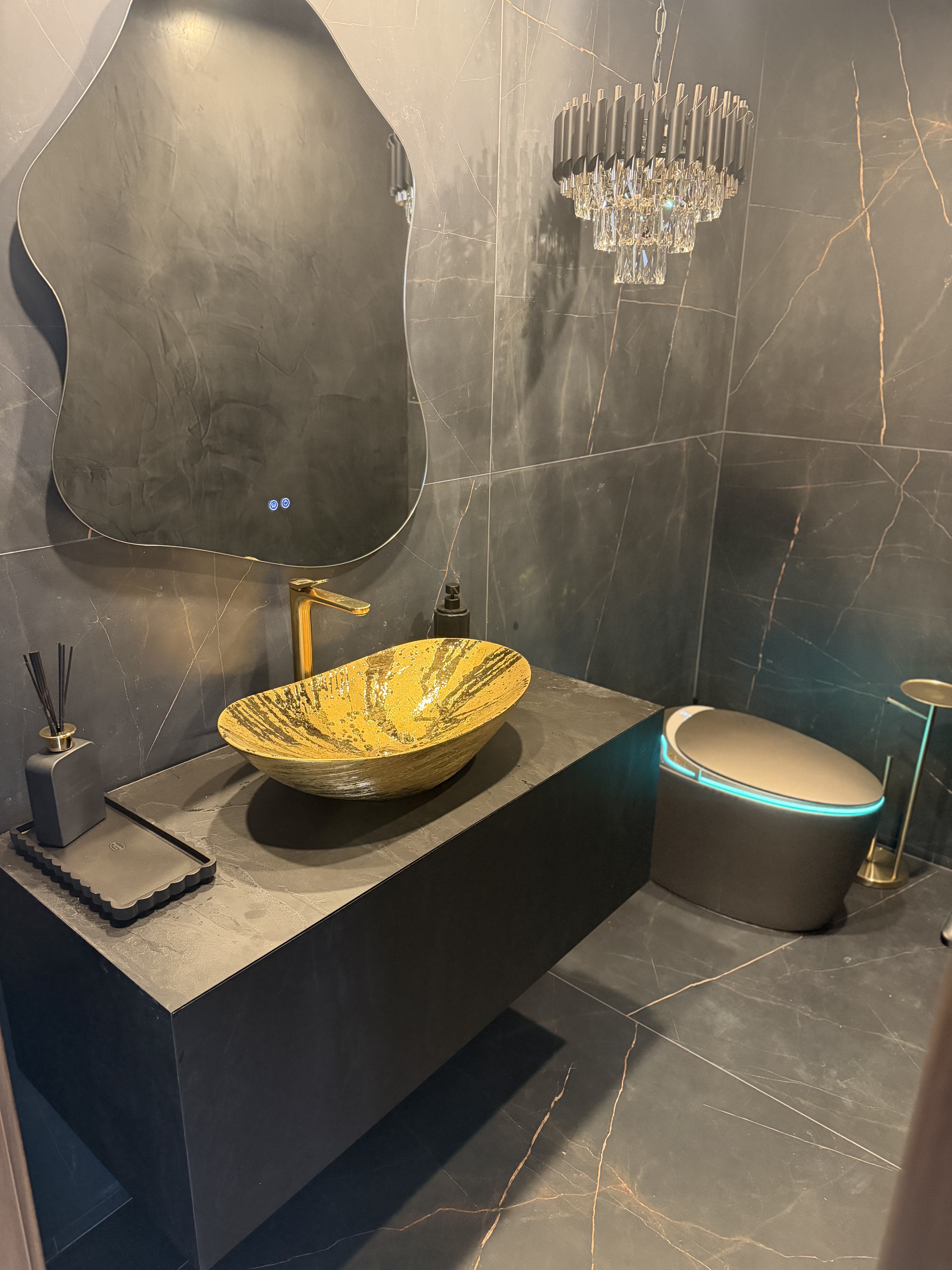 Gold vessel sink and smart heated toilet in a luxury bathroom remodel